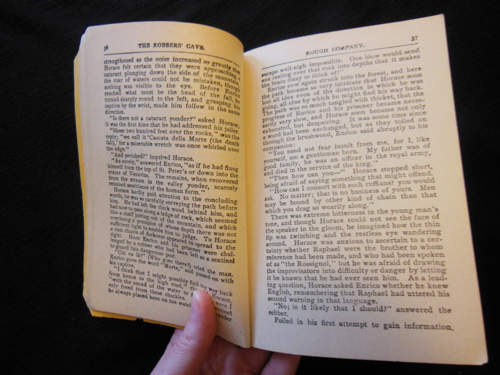 a hand holding an open book