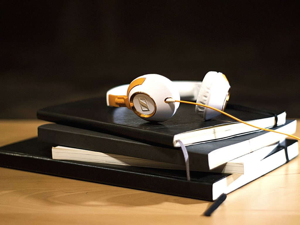Headphones on a stack of books for helping auditory learners