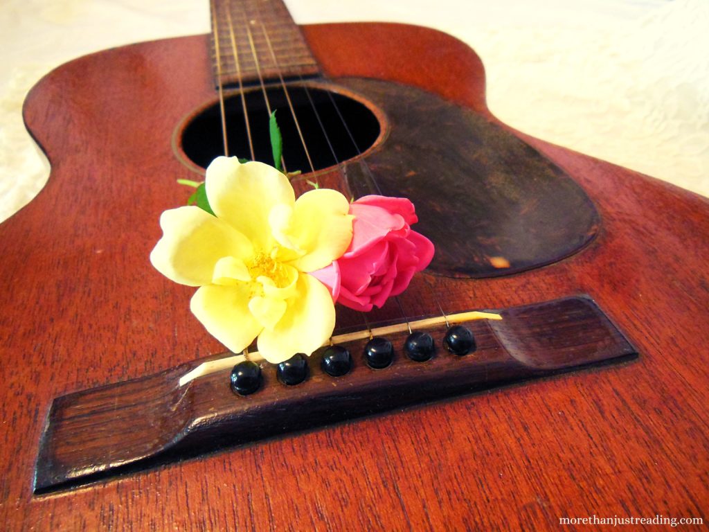 Roses resting on the head of a guitar