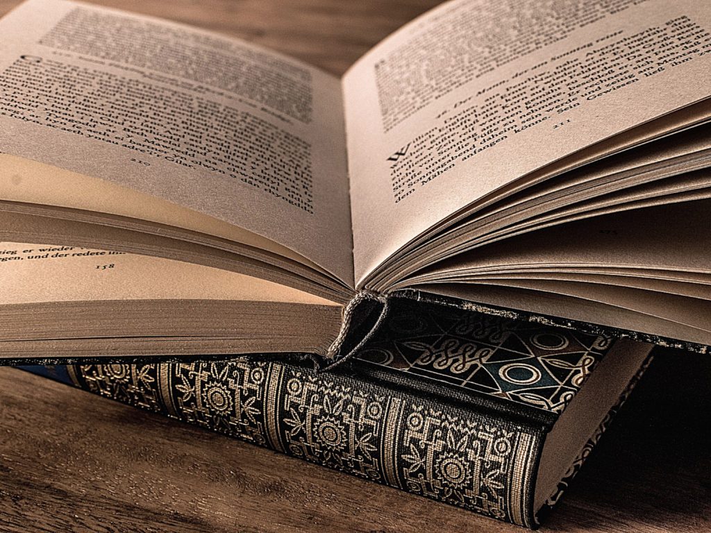 An open book on top of another book