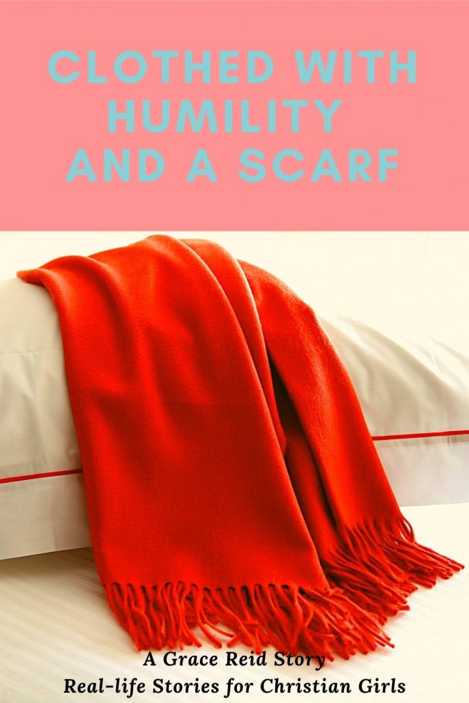 an orange scarf laying on a pillow | clothed with humility